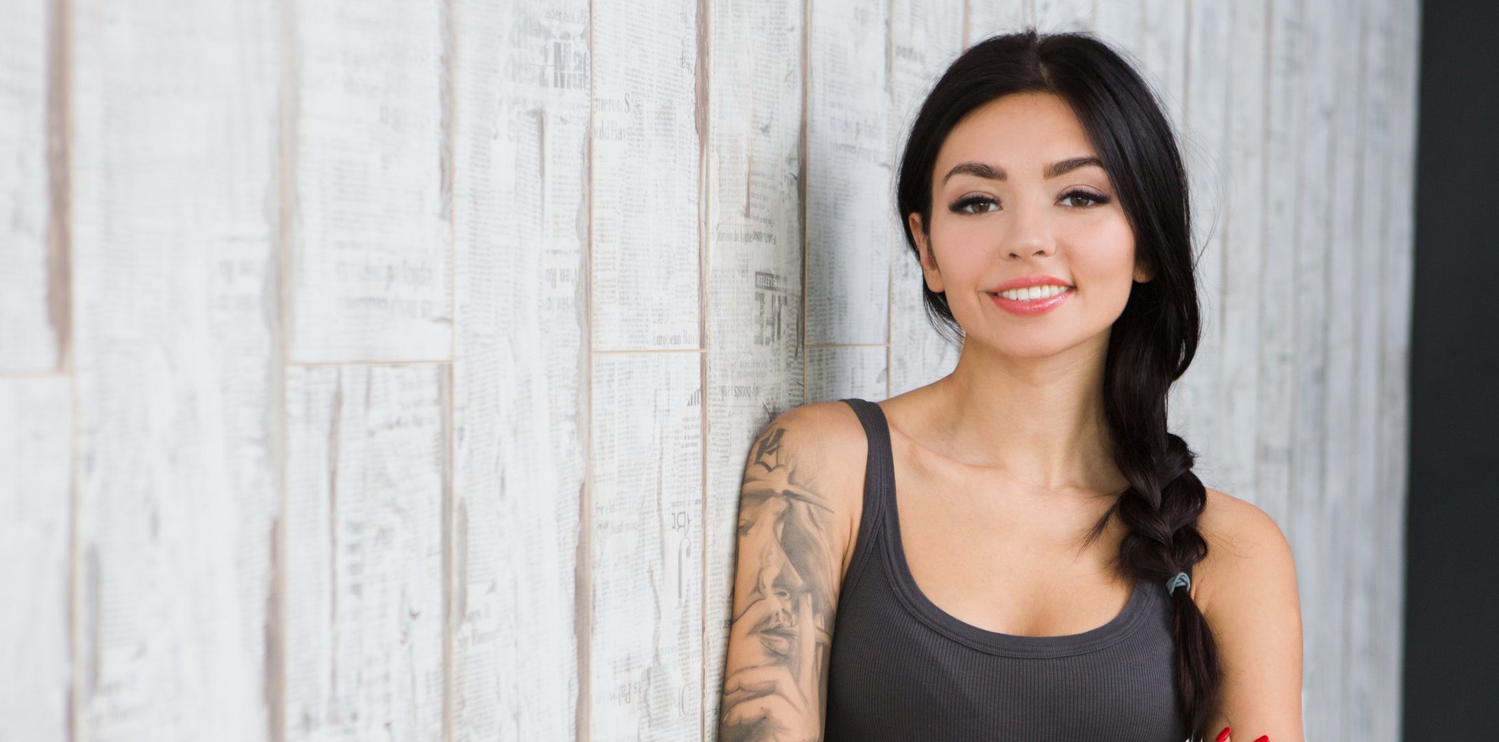young hopeful ambiguous woman with tattoos